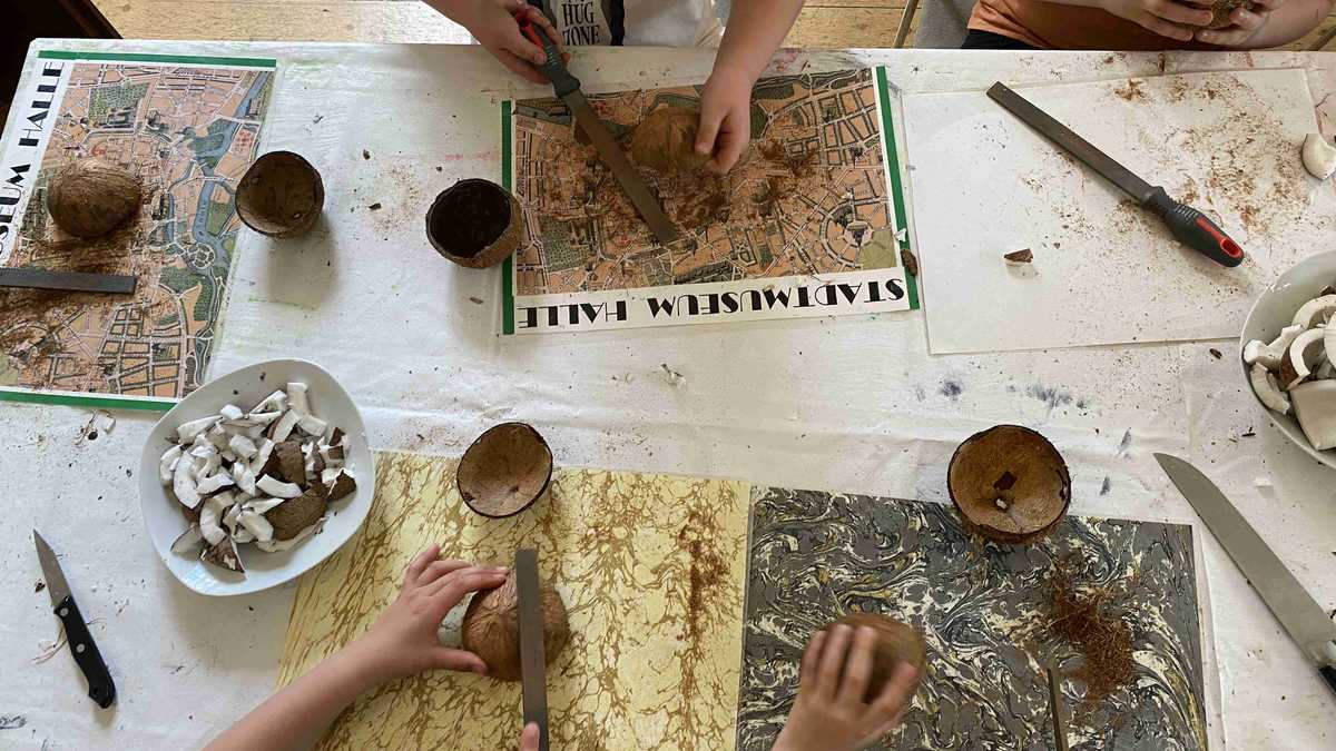 Kokosnuss als Rohstoff Kinder bearbeiten die schalen von Kokosnüssen